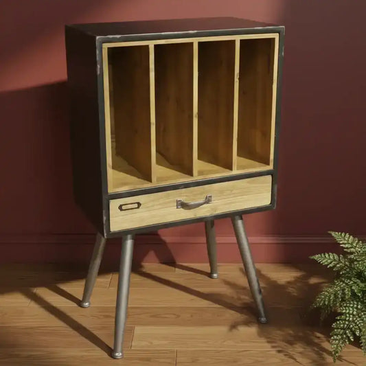 Wooden cabinet with metal legs against a red wall