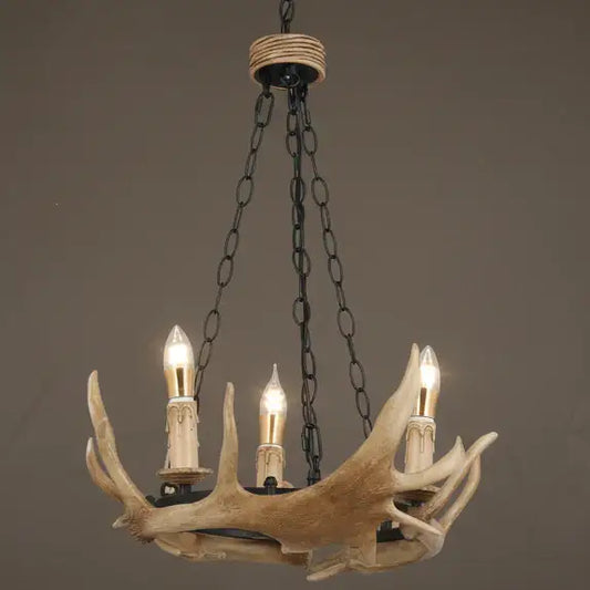 Chandelier with antler design and four light bulbs on a plain background