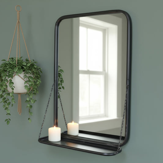Decorative mirror with a shelf hanging against a brick wall.