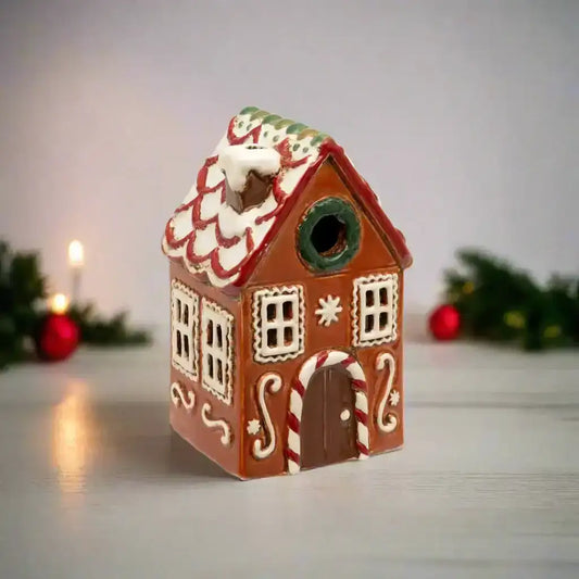 Decorative gingerbread house birdhouse on a white background