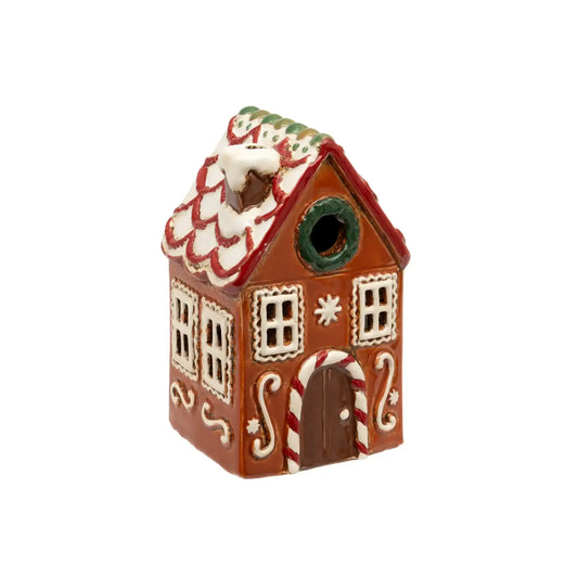 Decorative gingerbread house birdhouse on a white background