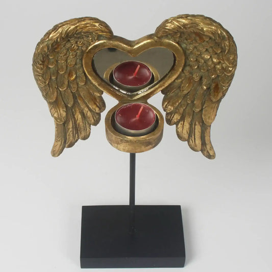 Decorative candle holder with gold angel wings and a heart design on a white background