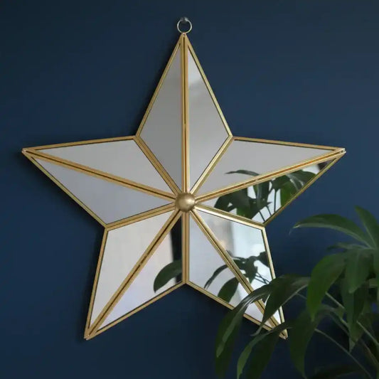 Star-shaped mirror with gold frame on a dark blue wall