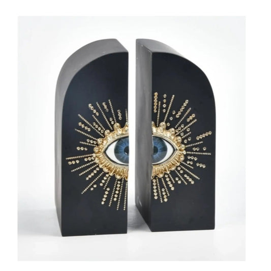 Decorative bookends with eye design on a white background