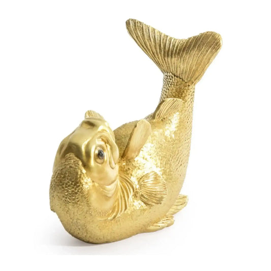 Gold fish figurine on a white background