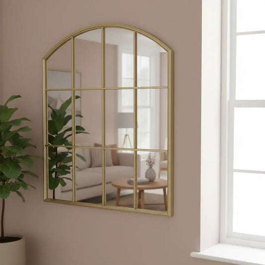 Gold-framed mirror on a brick wall