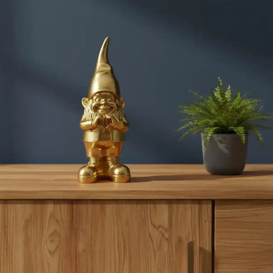 Gold gnome figurine on a wooden surface with a dark blue background