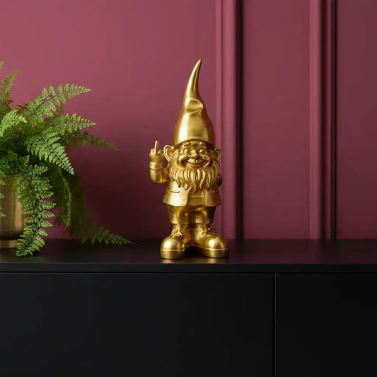 Gold gnome figurine on a white background