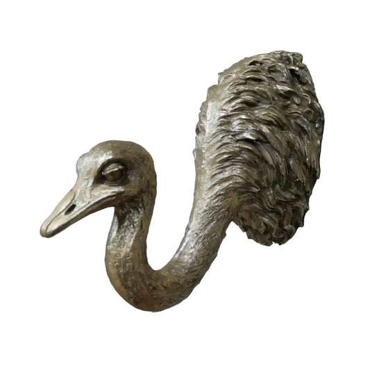 Bronze ostrich head sculpture on a brick wall