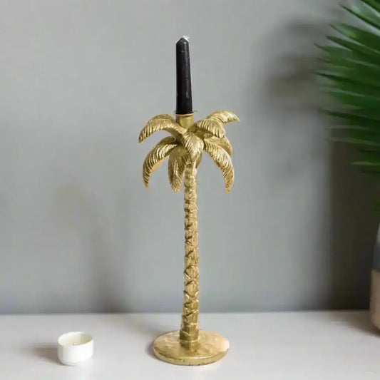 Gold palm tree candle holder on a white background