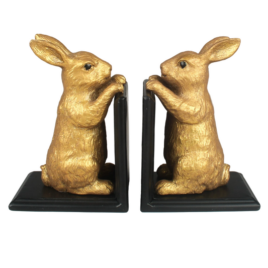 Gold rabbit bookends on a white background