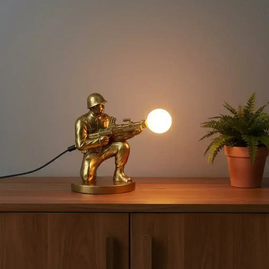 Gold-colored figurine of a soldier with a weapon on a white background