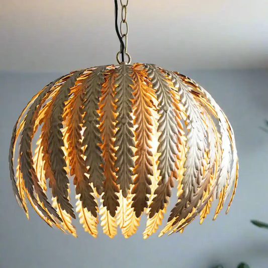 Decorative pendant light with leaf-like design on a blurred background