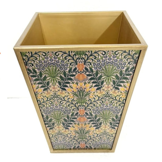 Decorative trash bin with floral pattern on a white background