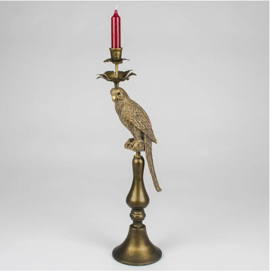 Decorative candle holder with parrot design on a white background