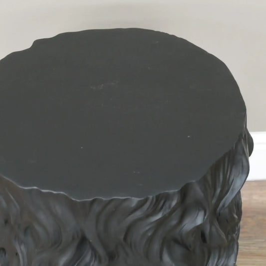 Black textured round table on a plain background