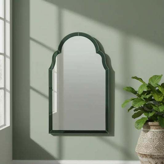 Wall mirror with green frame on a white background