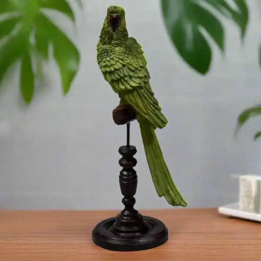 Green parrot figurine on a black stand against a white background