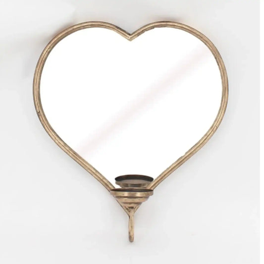 Heart-shaped mirror with a candle holder on a white background