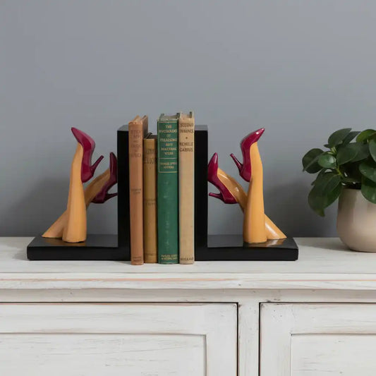 Bookends with high-heeled shoe design holding books on a white background