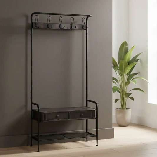 Black metal coat rack with a small table and hooks against a neutral wall with a plant.