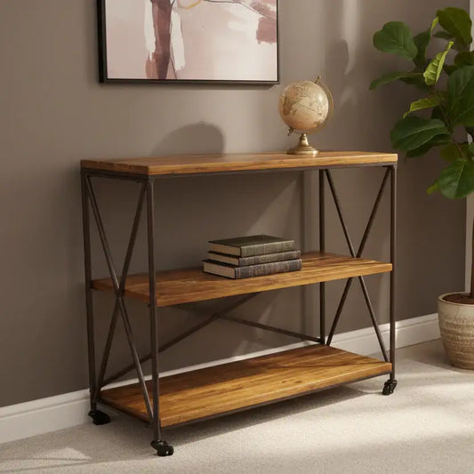 Wooden console table with metal legs against a wall with a framed picture and plant.
