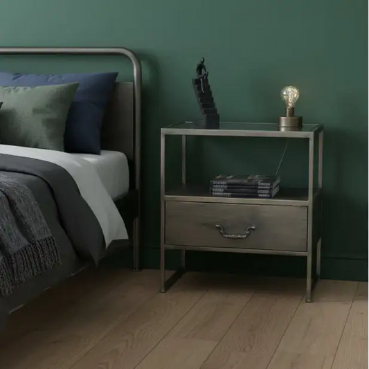 Bedroom with a bed and nightstand against a green wall