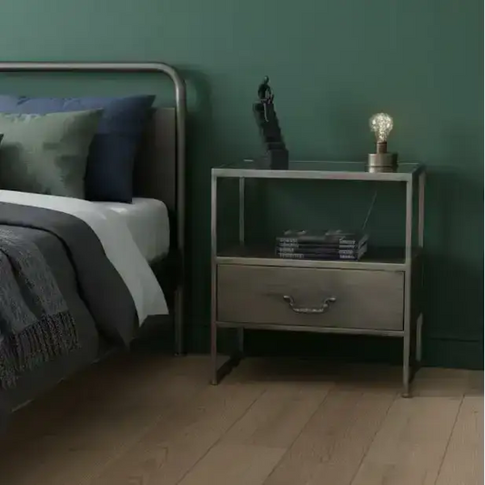 Bedroom with a bed and nightstand against a green wall