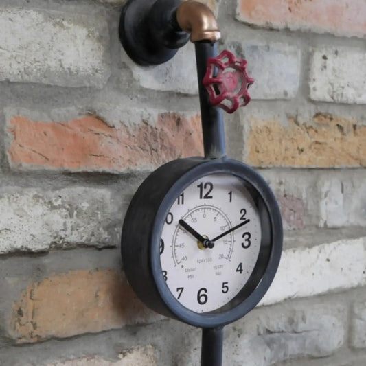 Decorative clock with industrial design on a brick wall