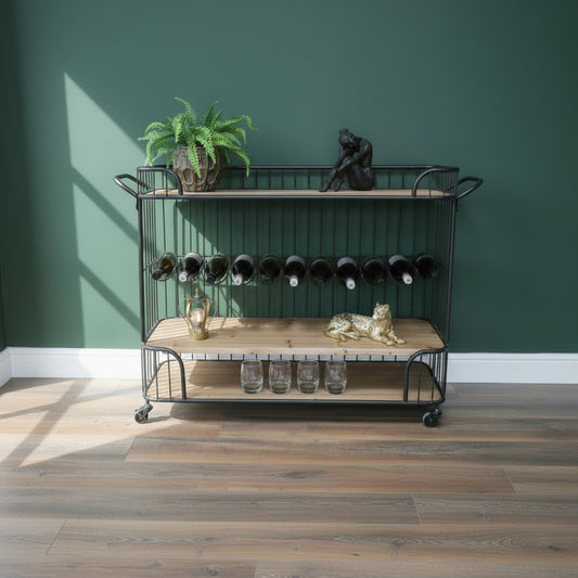 Bar cart with wine bottles and decorative items on a wooden floor.