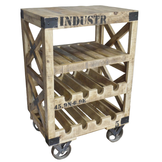 A rustic industrial-style wooden rolling cart with three tiers, featuring a top shelf as a small table, wine bottle slots on the middle and bottom tiers, and black metal corner brackets and stenciled text, shown on a wood floor against a gray wall.