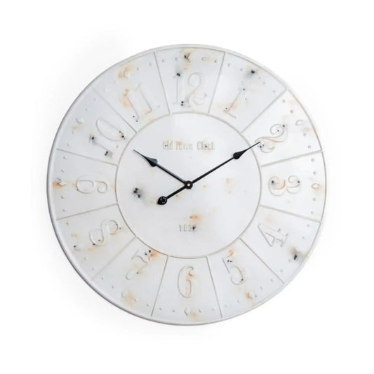 Round wall clock with decorative design on a white background
