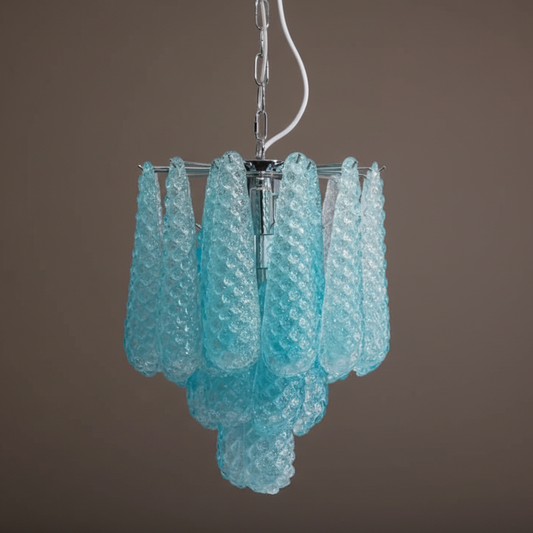 Turquoise glass chandelier against a brown background