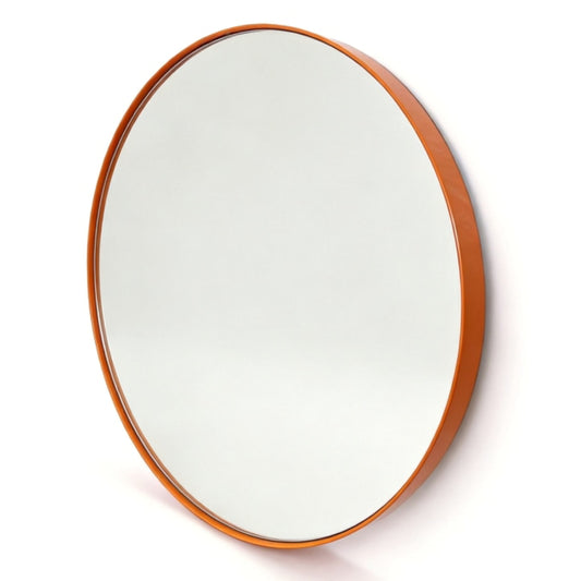 An oval wall mirror with a warm orange-brown wooden frame, shown at a slight angle against a plain white background.