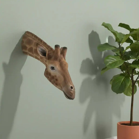 Giraffe head sculpture on a plain background