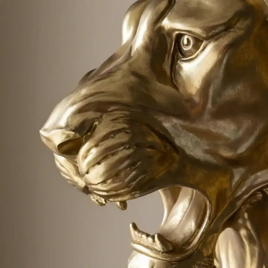 Close-up of a gold tiger statue against a dark background