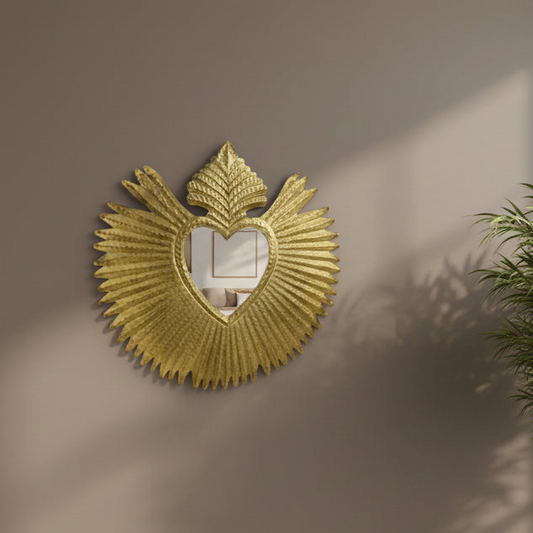 Decorative gold mirror with fan-like design on a beige wall