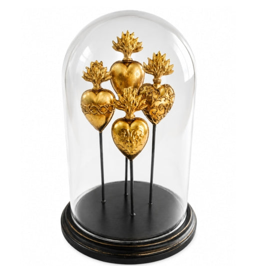 Decorative display of gold hearts under a glass dome on a white background