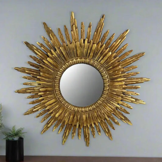 Gold sunburst mirror on a white background
