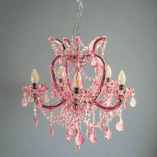 Pink chandelier with crystal accents on a white background