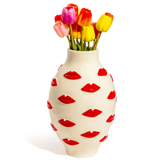 Vase with red lip prints and colorful tulips on a white background