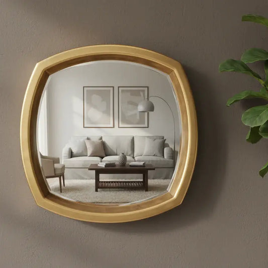 Gold-framed mirror reflecting a living room with a sofa and coffee table.