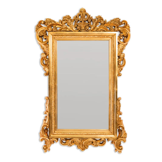 Decorative gold mirror with intricate patterns on a white background