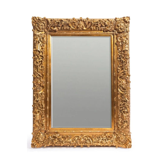 Decorative gold-framed mirror on a white background