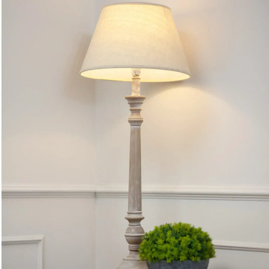 Floor lamp with a white shade in a room setting