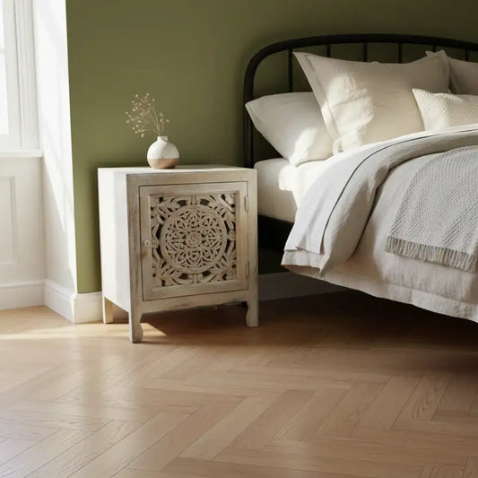 Bedroom with a wooden nightstand and bed with white bedding.