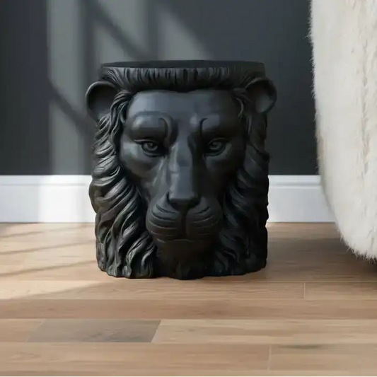 Black lion head sculpture on a wooden floor with a dark wall background