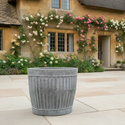 Decorative planter in front of a house with floral arches