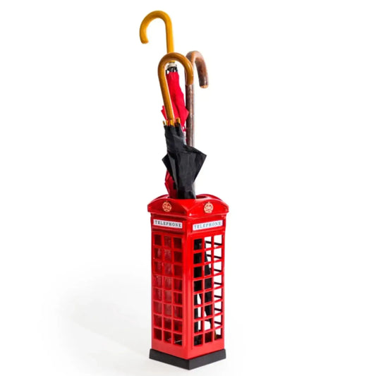 Red phone booth-shaped umbrella stand with a black umbrella inside on a white background