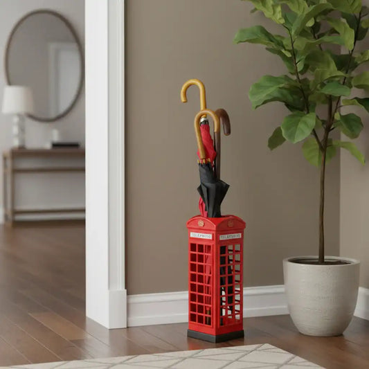 Red umbrella stand with a phone box design next to a potted plant in a room.